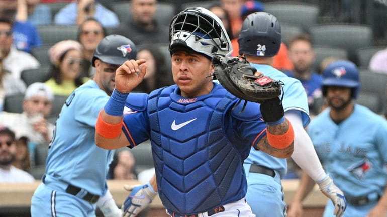 Mets catcher Francisco Alvarez reacts after the Blue Jays' Matt...