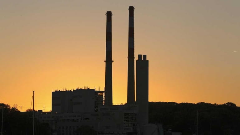 LIPA power plants towers are seen at sunset over Port...