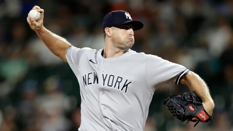 Yankees closing pitcher Clay Holmes works against the Mariners during...