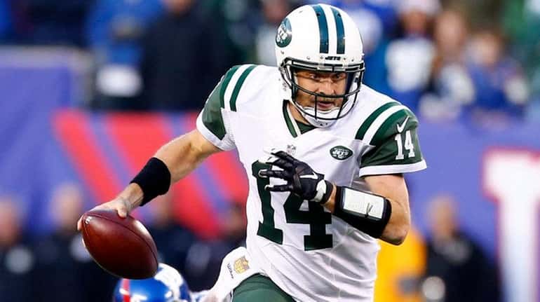 Ryan Fitzpatrick #14 of the New York Jets scrambles with...