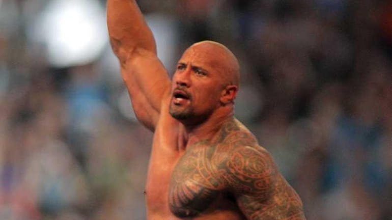 Dwyane 'The Rock' Johnson celebrates after defeating John Cena at...