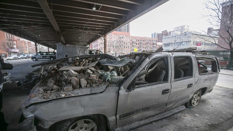 Crushed cars on March 15, 2014, under the Metro-North train...