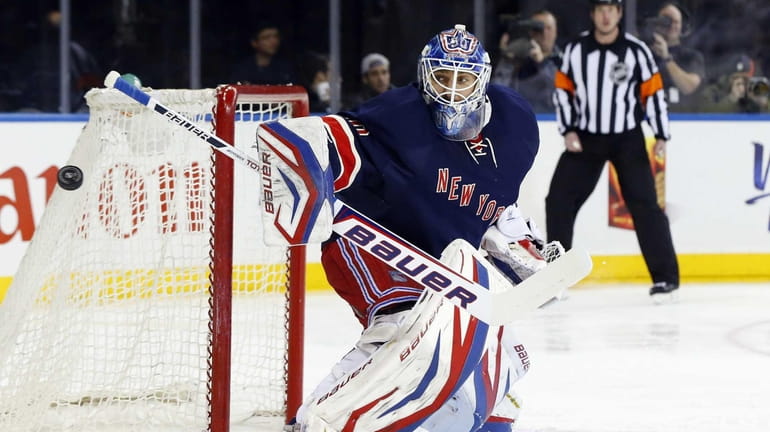 Henrik Lundqvist defends the net in the first period of...