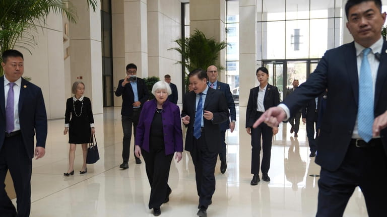 U.S. Treasury Secretary Janet Yellen, center left, walks with Governor...