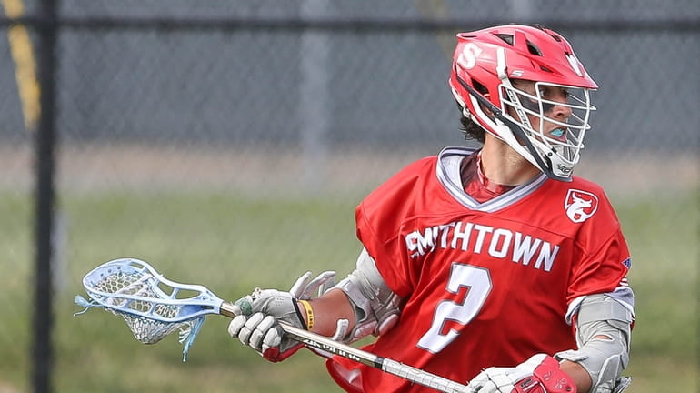Smithtown East's Joe Hobot (2) brings the ball around the...