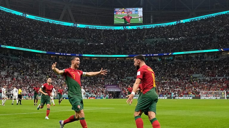 Portugal's Cristiano Ronaldo celebrates his side's opening goal with Portugal's...