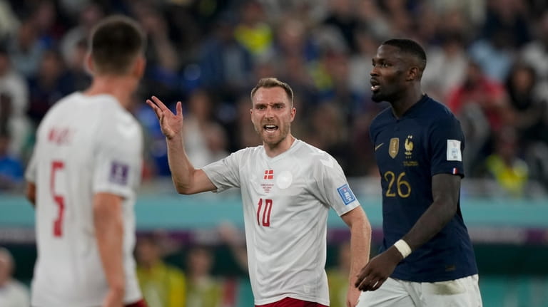 Denmark's Christian Eriksen, center, reacts during the World Cup group...