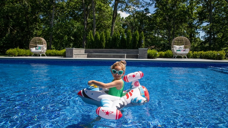 Harlow Grober, 5, in a pool float at her pool...