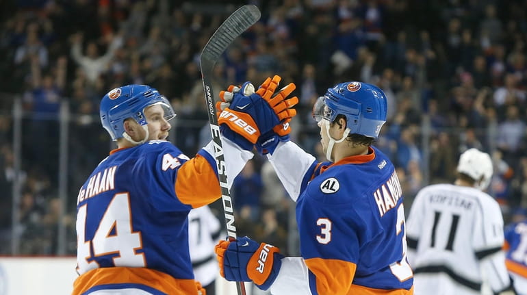 Travis Hamonic #3 of the New York Islanders celebrates his...