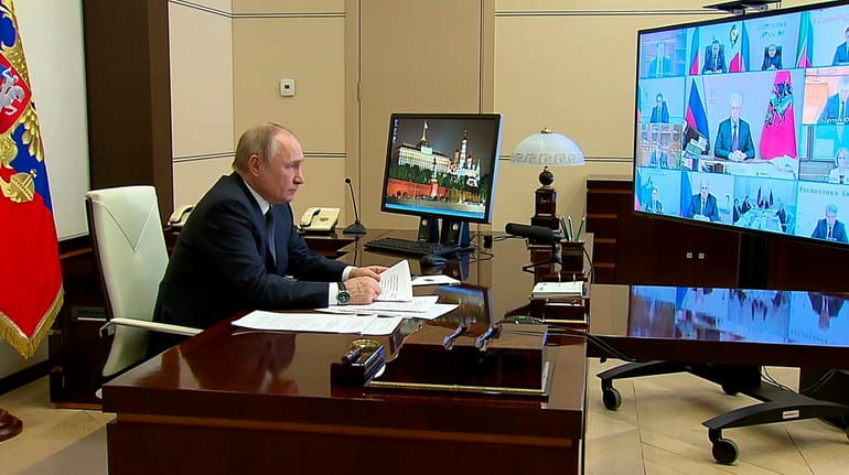 Russian President Vladimir Putin speaks from the Novo-Ogaryovo residence outside Moscow...