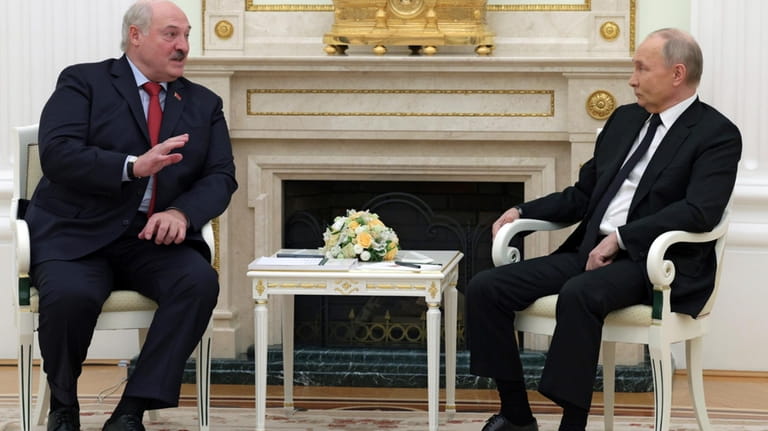 Russian President Vladimir Putin, right, listens to Belarus President Alexander...