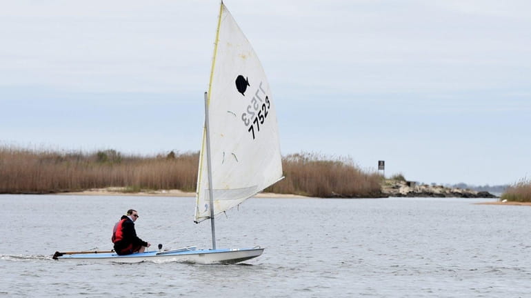Bay Shore High School student Ben Finley, 15, enjoys sailing...