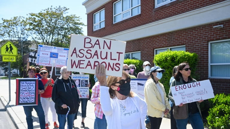 Anne Smalley, center, of Westhampton Beach, and other protesters rally Wednesday...