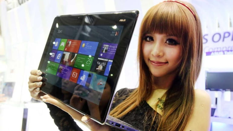A model shows Asus, the new Taichi notebook with two...