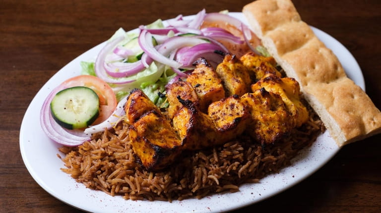 The chicken tikka kebab features marinated cubes of meat grilled over...