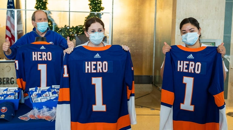 Islanders co-owner Jon Ledecky, left, poses with nurses Lauren Mendelson...