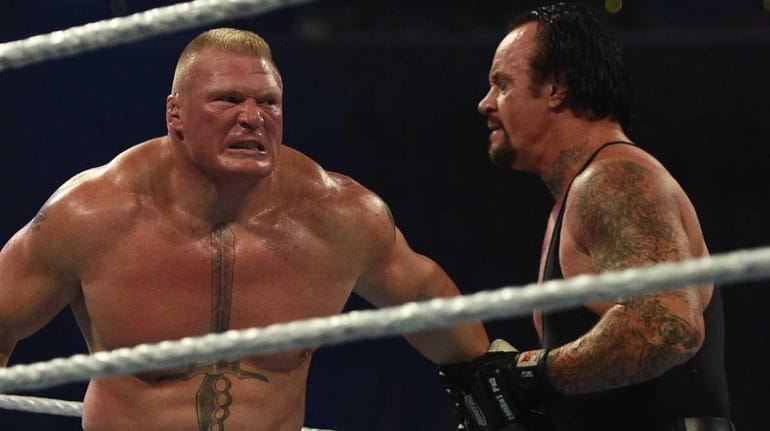Brock Lesnar, left, and The Undertaker, wrestle during the WWE...