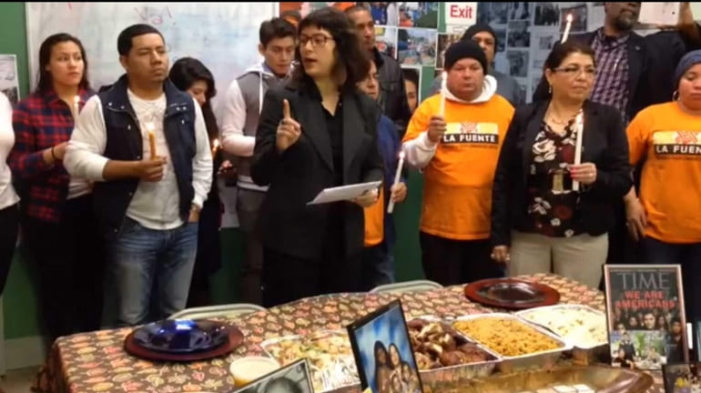 Community organizer Karina Claudio-Betancourt, center, leads a Thanksgiving call for...