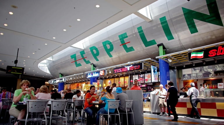 Customers eat at the food court at Roosevelt Field on July...