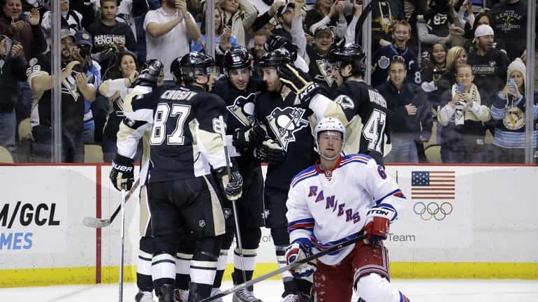 Pittsburgh Penguins' Sidney Crosby celebrates his goal with teammates behind...