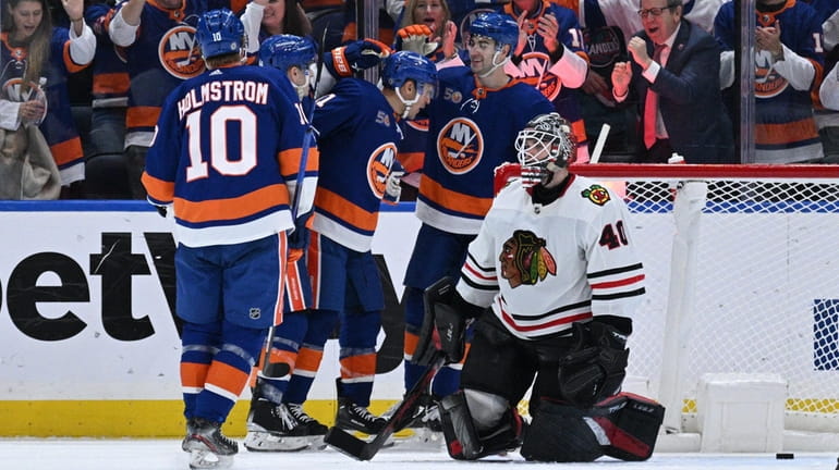 New York Islanders players celebrate a goal by left wing...