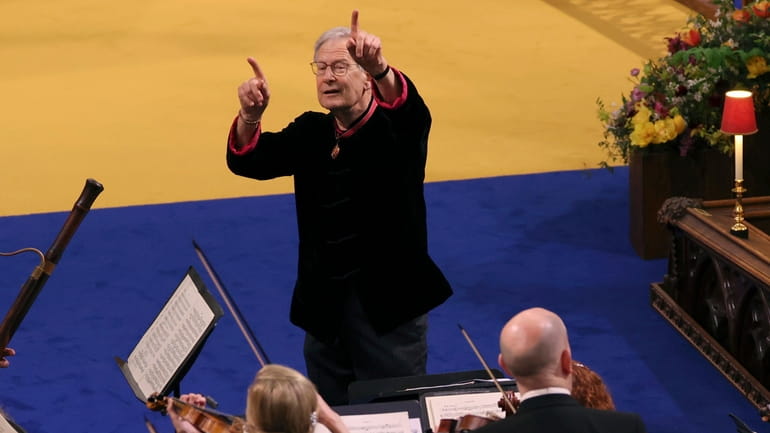 Conductor John Eliot Gardiner leads musicians as they perform in...