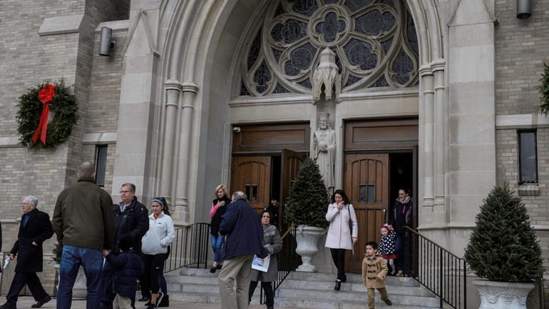 Churchgoers leave the Diocese of Rockville Centre's St. Agnes Cathedral after...