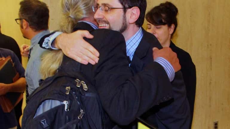 Jesse Friedman hugs his attorney, Ronald Kuby, after Judge F....