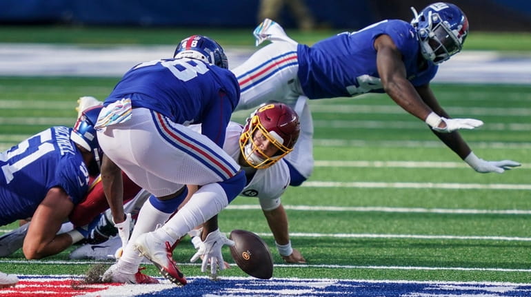 Washington Football Team quarterback Kyle Allen (8) loses control of...