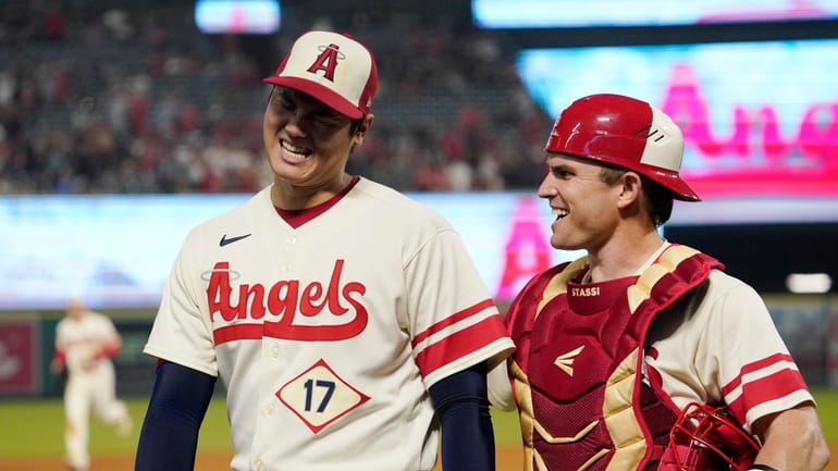 Los Angeles Angels starting pitcher Shohei Ohtani, left, talks with...