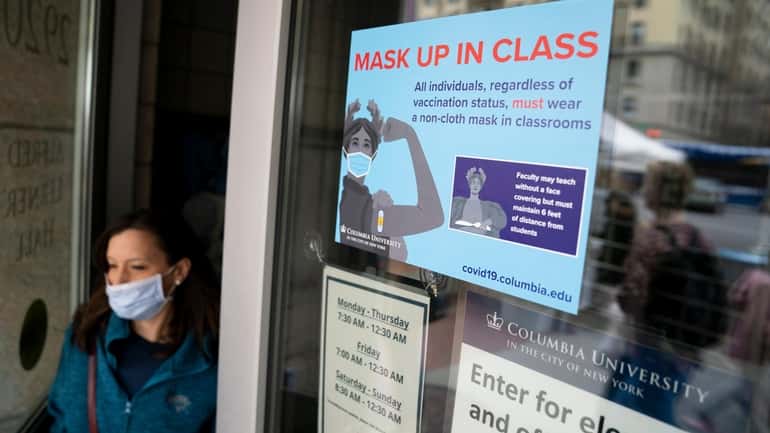 Signs indicating that protective face masks must be worn in...