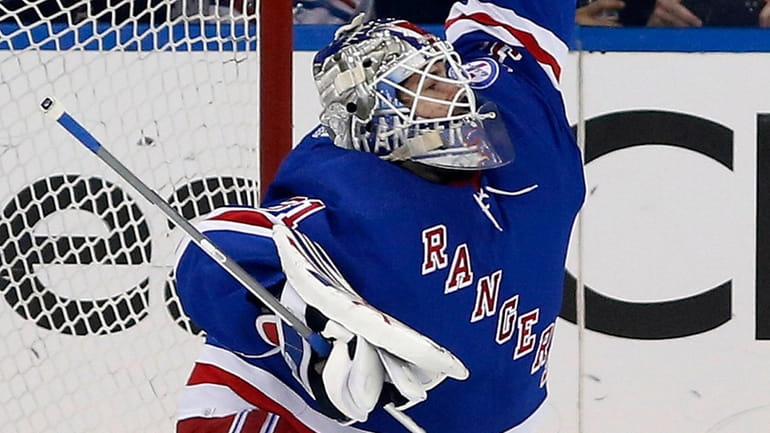 Igor Shesterkin of the Rangers makes a glove save during the...