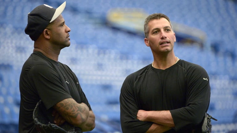 CC Sabathia, left, and Andy Pettitte chat before a game...
