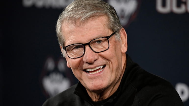 UConn coach Geno Auriemma smiles after gaining his 1,200th career...