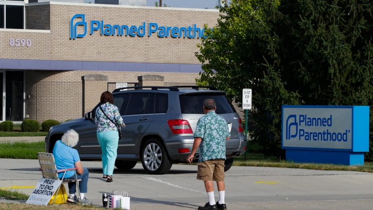 Abortion protesters attempt to hand out literature at a Planned...