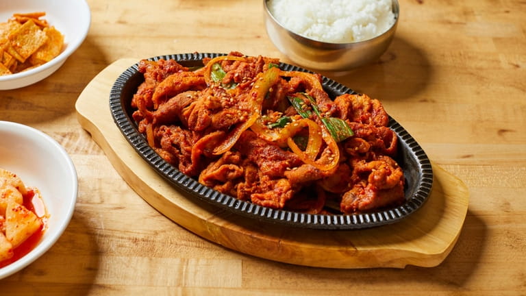 Daeji bulgogi, barbecued and marinated spicy pork rib, served with...
