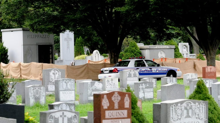 Police investigate a body stolen out of a coffin at...
