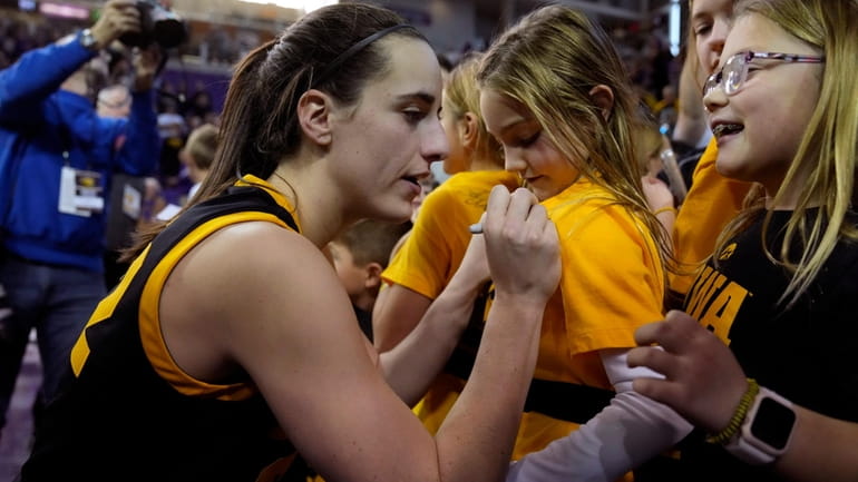 Iowa guard Caitlin Clark signs autographs after an NCAA college...