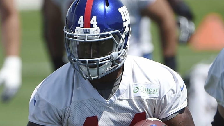 New York Giants running back Andre Williams runs with the...