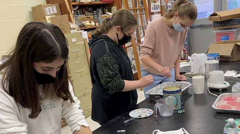 Bellport High School's Art Club members created face masks with...