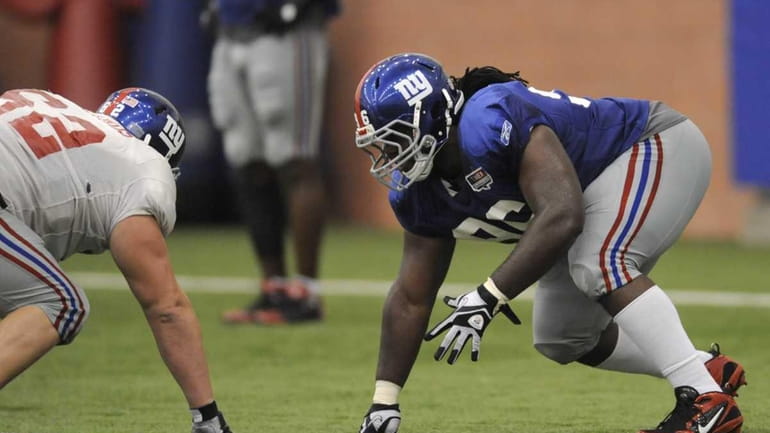 New York Giants defensive tackle Marvin Austin, right, lines up...