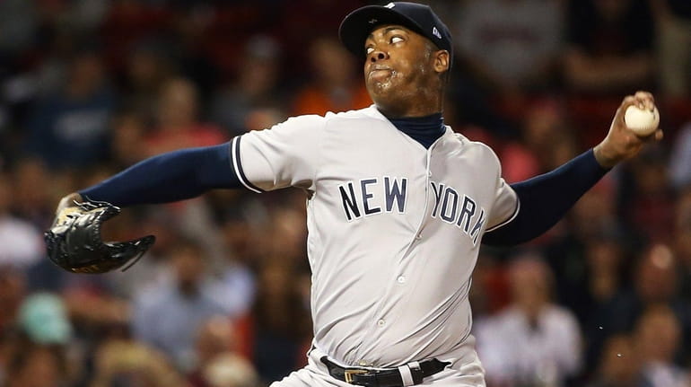 Aroldis Chapman of the Yankees delivers in the ninth inning...