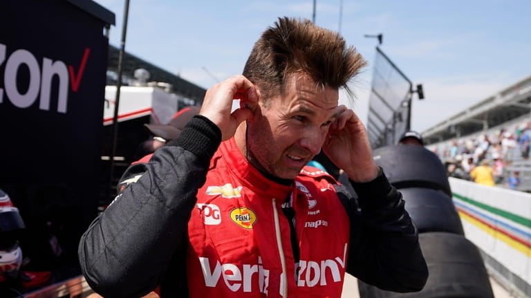 Will Power, of Australia, talks with a crew member following...