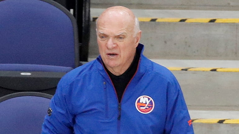 Islanders general manager Lou Lamoriello watches his team during practice...