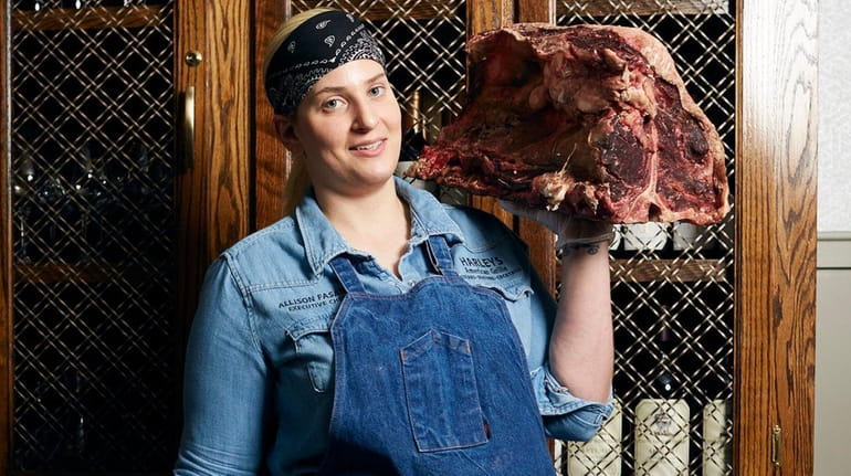 Executive chef Allison Fasano of Harleys American Grille hoists a...