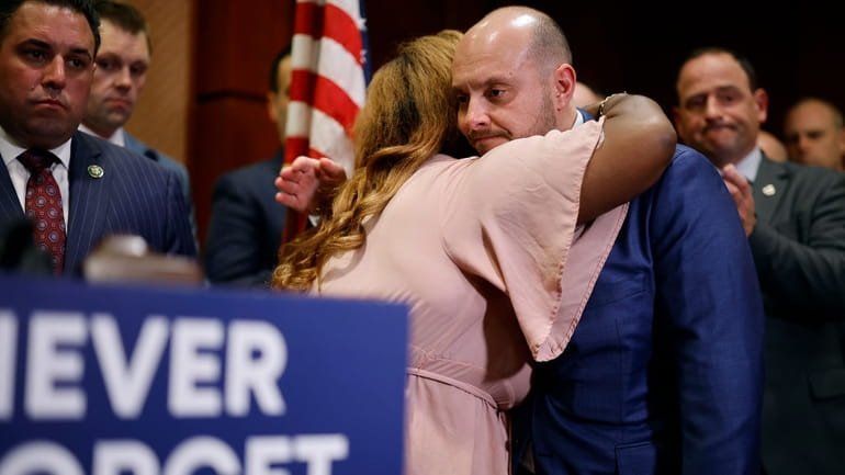 Rep. Andrew Garbarino hugs 9/11 survivor advocate Mariama James during a...