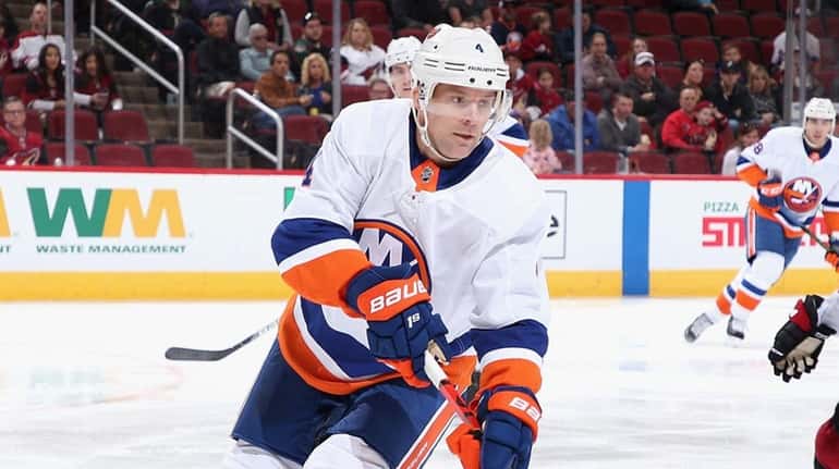 Andy Greene #4 of the Islanders skates with the puck...