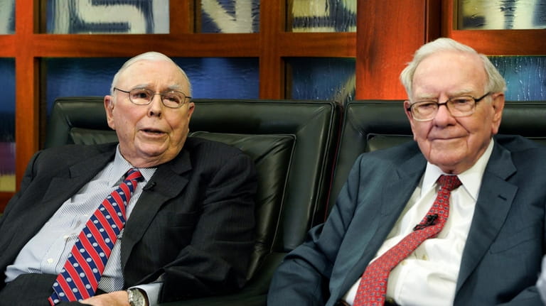 Berkshire Hathaway Chairman and CEO Warren Buffett, right, and his...