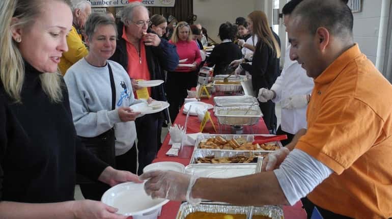 Servers ladle out samples at the Souper Bowl, which takes...