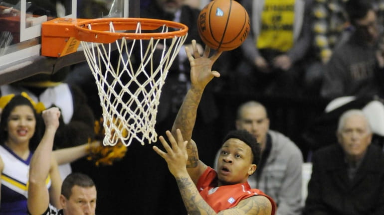 Stony Brook's Rayshaun McGrew scores against Albany during the first...